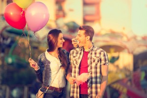 Love couple in amusement park with cotton candy have fun