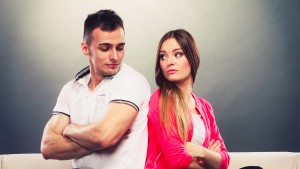 Young Couple After Quarrel Sitting On Sofa Back To Back
