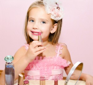 Child cosmetics Cute little girl with lipstick isolated