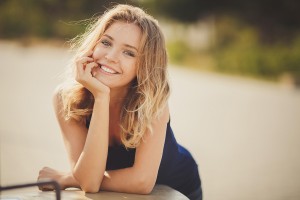 Romantic young woman with beautiful smile having a rest outdoor.