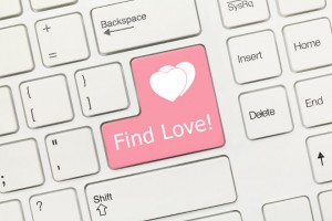 Close-up view on white conceptual keyboard - Find Love (pink key)