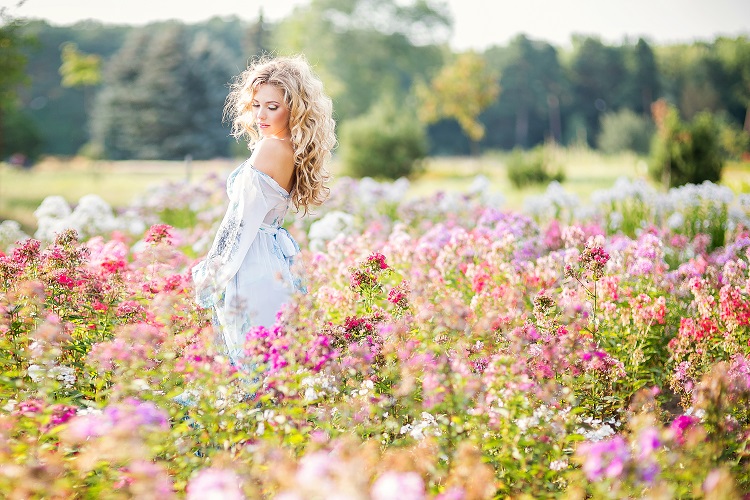 beautiful young girl in a garden of flowers