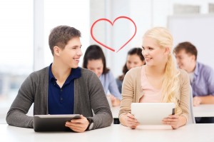 education, technology and internet - two smiling students lookin