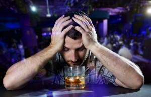 Alcoholic Drunk Man thinking On Alcohol Addiction At Disco Night
