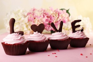 Delicious Valentine Day cupcakes on light background
