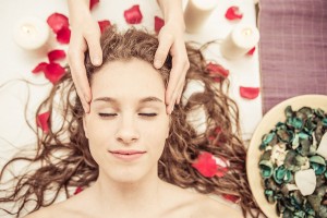 head massage. young woman making massage in the spa. concept about beauty spa and massages