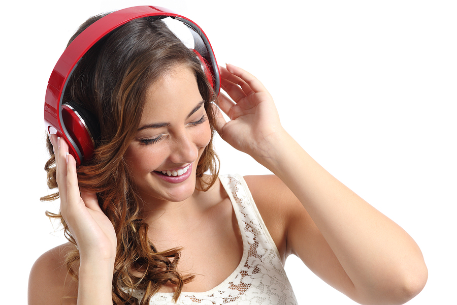 Young Happy Woman Enjoying Listening To The Music From Headphone