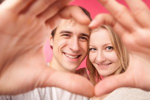 Girl and her boyfriend making heart