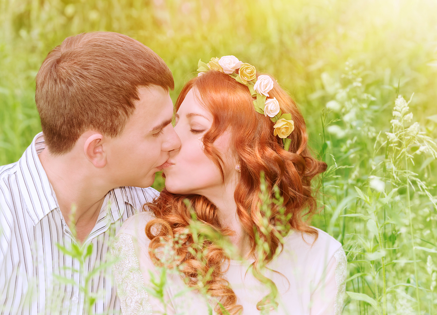 Closeup portrait of beautiful young couple kissing outdoors, spe