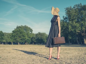 Elegant Young Woman With Briefcase Standing In Park