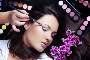 Make-up artist making eye visage to beautiful woman