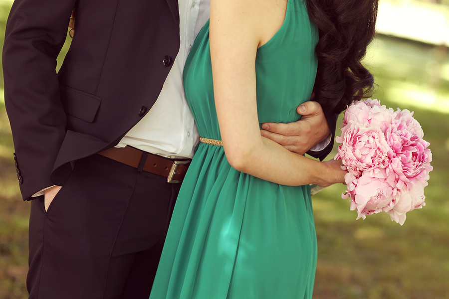 Men Hugging His Woman. Woman Holding Bouquet Of Peonies