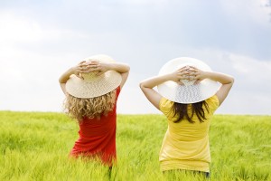 two girls in a wheat field, two friends enjoying the open air
