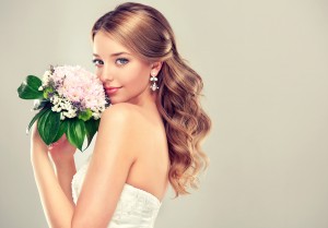 Girl bride  in wedding dress with elegant hairstyle and with a w