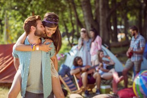 Hipster couple having fun on campsite at a music festival