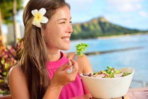 Salad eating healthy woman at restaurant in Hawaii. Asian Multir