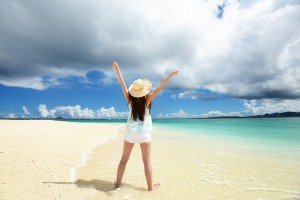 Picture of a beautiful beach in Okinawa, with a woman on the beach.
