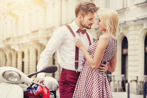 Young funny pretty fashion vintage hipster couple having fun outdoor on the street in summer.