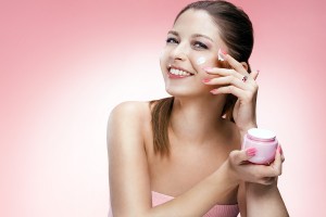 Applying cosmetic cream on face