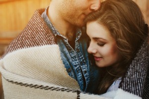 Young couple wrapped in plaid