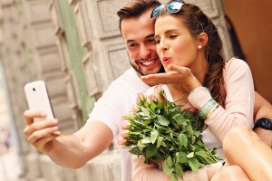 A picture of a young romantic couple using smartphone in the cit