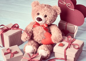 Valentines Day. Teddy Bear Love.Gift boxes on wood